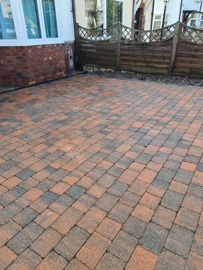 Block paving driveway pressure washed clean by the conservatory
