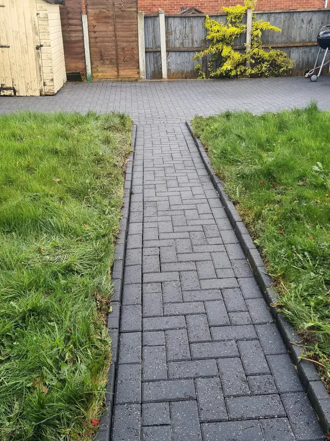 Grey block paving driveway cleaned of moss and weeds