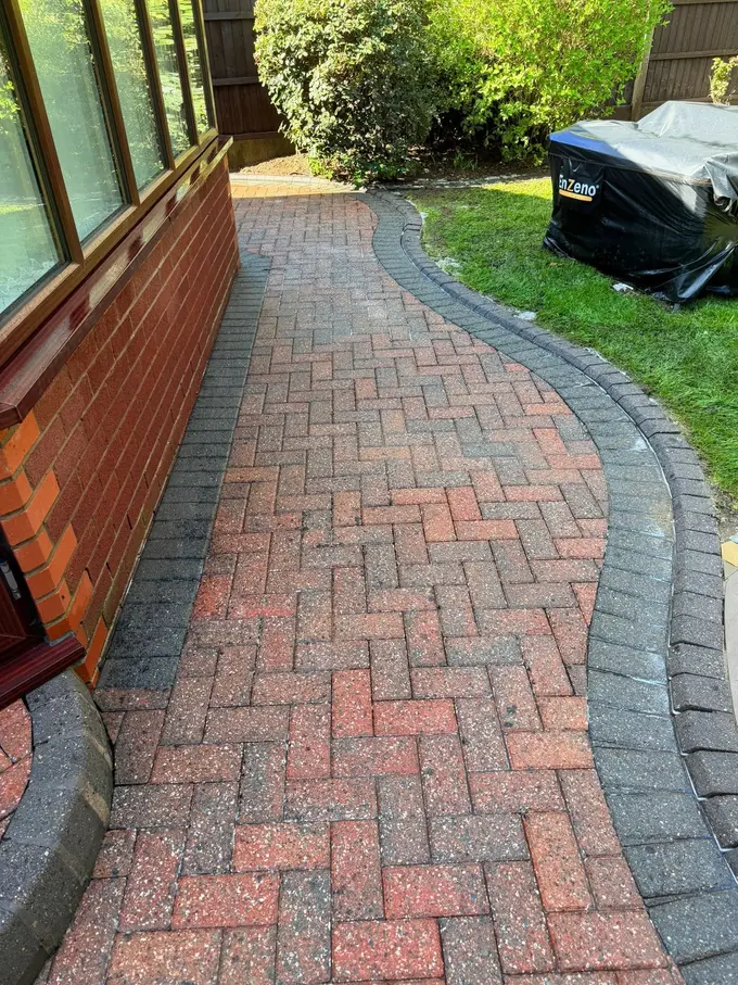 Block paving path cleaned back to a fresh red finish