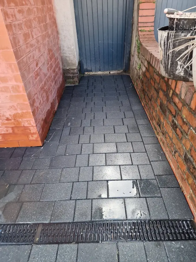 Block paving path and channel drain jet washed clean