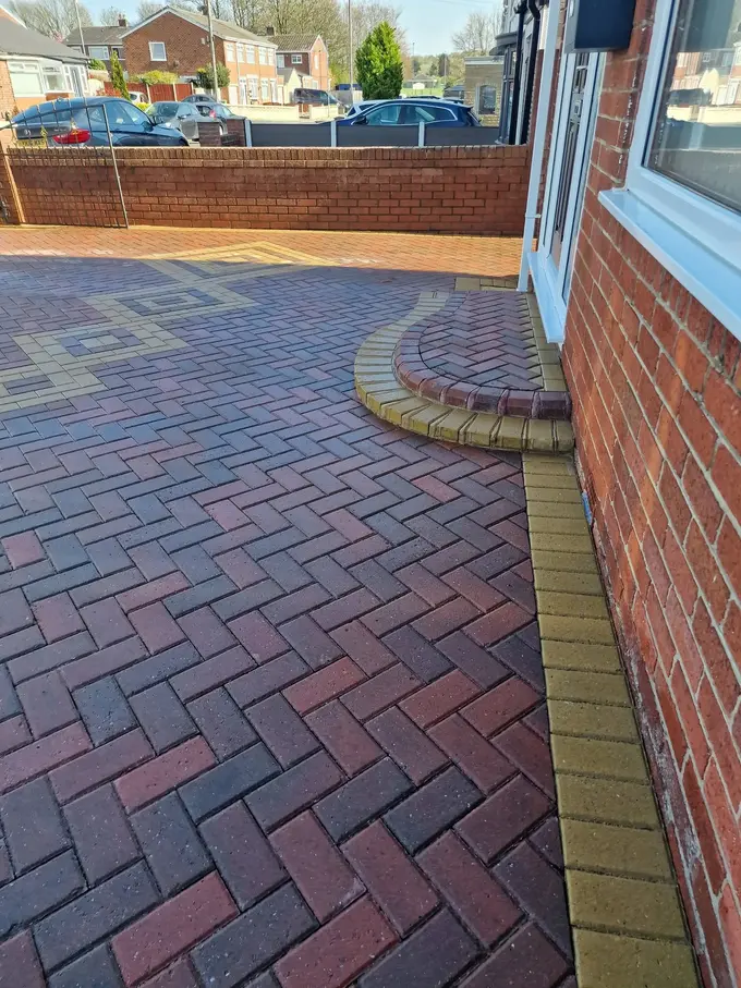 Red block paving driveway cleaned around the house