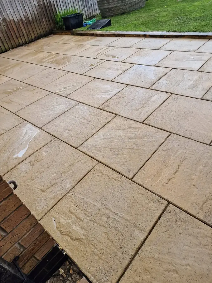 Buff sandstone patio jet washed clean of dirt and moss