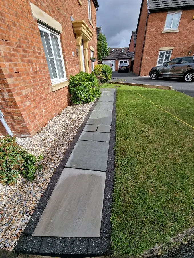 Grey flag path cleaned across the front garden