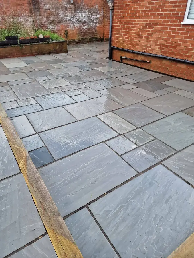 Riven grey sandstone patio cleaned back to colour