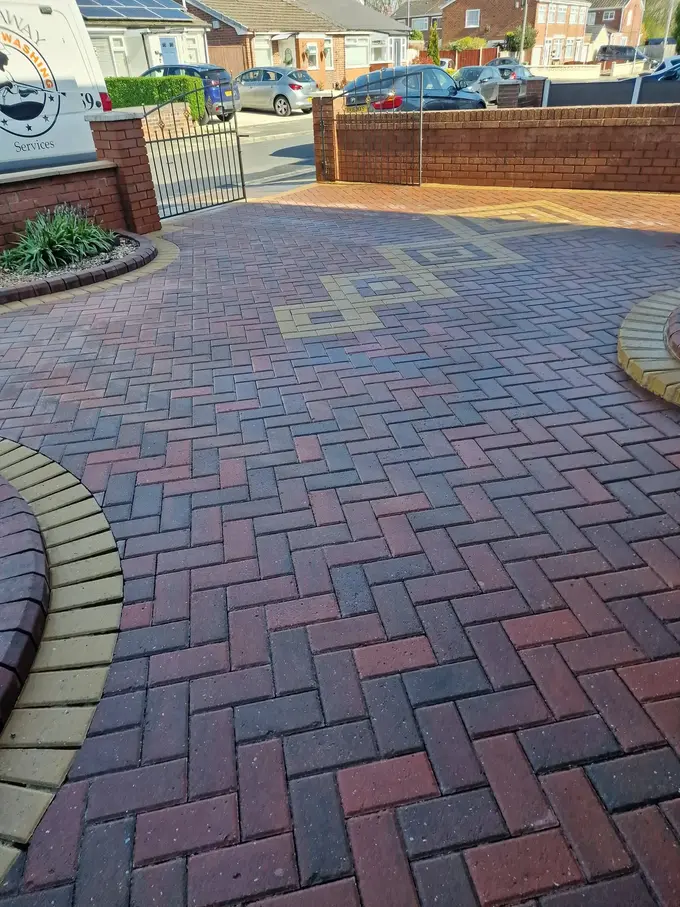 Block paving driveway with a circular feature cleaned