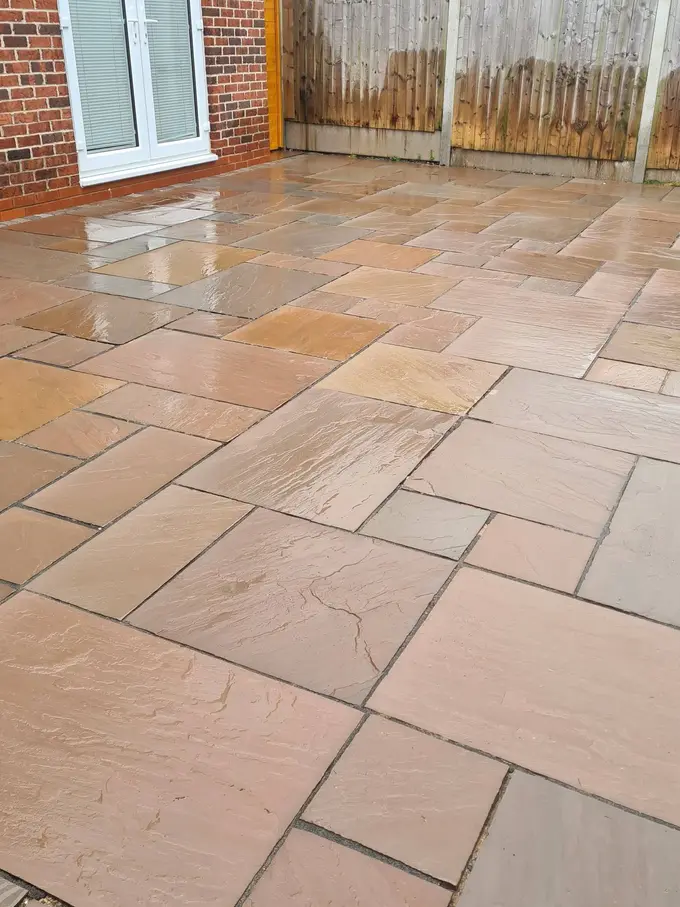 Buff sandstone patio jet washed clean of green algae