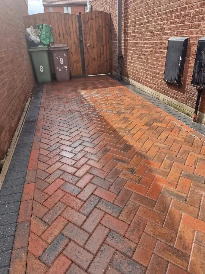 Red block paved courtyard cleaned of moss and weeds