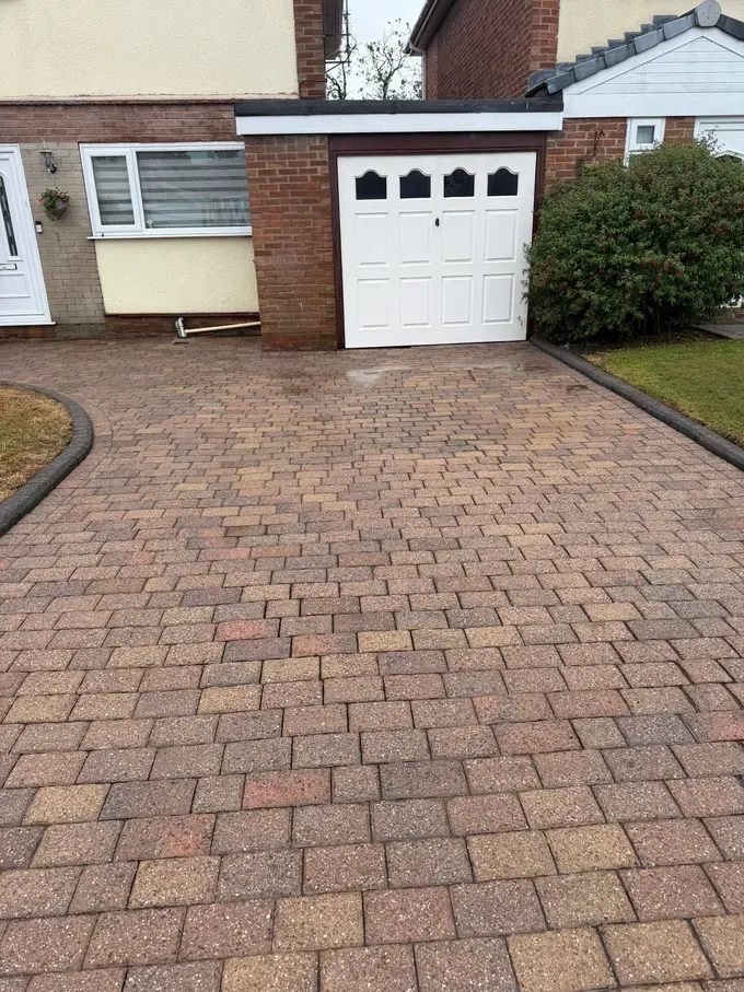 Block paving driveway cleaned up to the garage door