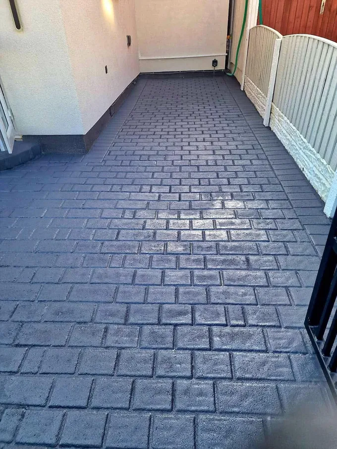 Block paving path in Prescot cleaned back to a deep, even finish between the house and fence