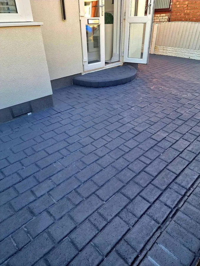 Block paved patio and doorstep in Prescot cleaned back to a rich charcoal finish