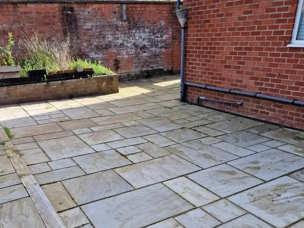 Grey sandstone patio cleaned back to its natural colour
